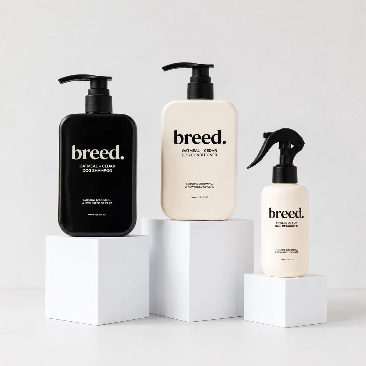 Breed product range — shampoo, conditioner and detangler on white pedestals